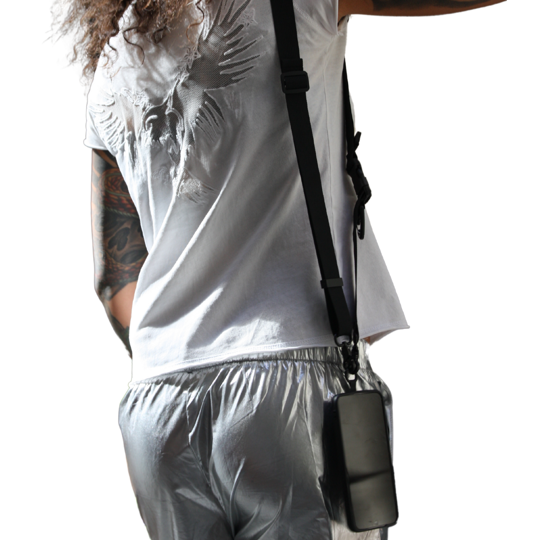 Girl shows her back side. Wearing 2-in-1 Utility Lanyard Crossbody phone strap black.