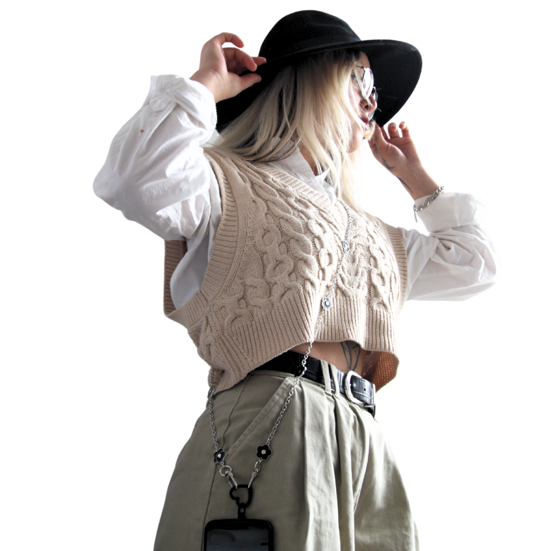 Girl standing and holding her hat. Wearing the black and silver flower crossbody phone strap.