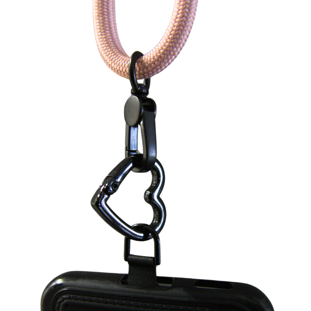 White background. Heart carabiner connected with the rope and the phone.